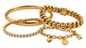A gold bangle, a curb link bracelet, a tennis-style bracelet and a charm bracelet