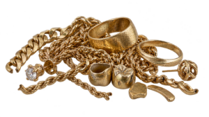 A mixed pile of scrap gold: broken chains, single earrings, bent rings, old dental-style gold and odd pieces
